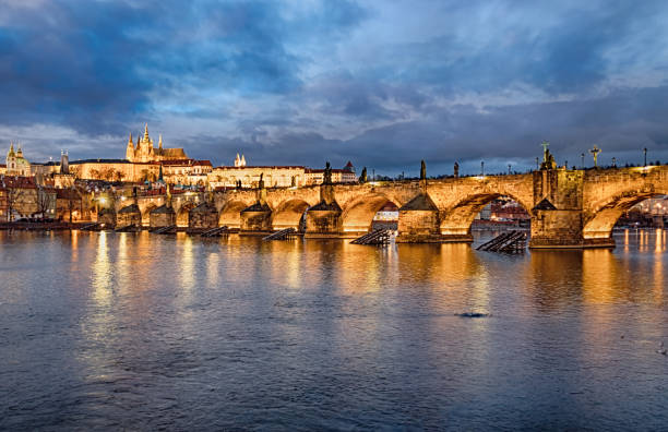 istock Multiple exposure of Prague and Charles Bridge over Vltava river at sunset 1227373972