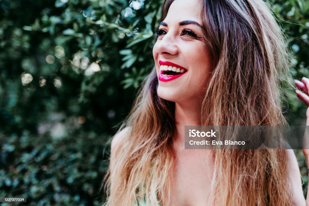 portrait of beautiful blonde young woman smiling at sunset. Red lips and gorgeous smile. Happiness concept Laughing Stock Photo