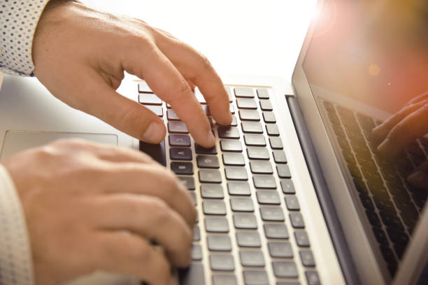 istock Closeup of man’s hands typing on laptop keyboard. 1227380224