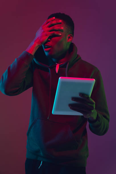 istock African-american man's portrait isolated on gradient studio background in neon light 1227383213