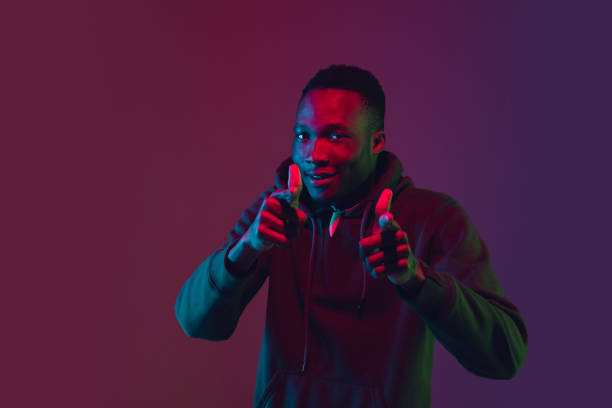istock African-american man's portrait isolated on gradient studio background in neon light 1227383215