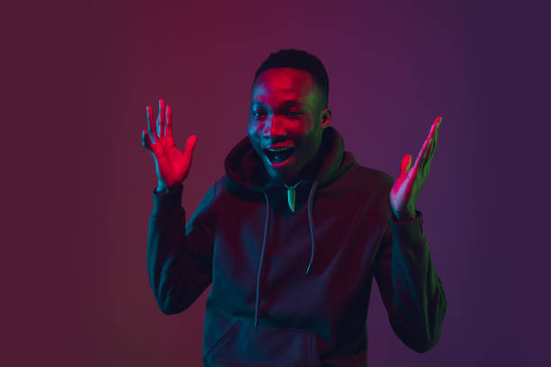 istock African-american man's portrait isolated on gradient studio background in neon light 1227383217