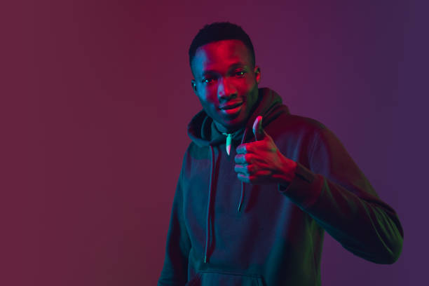 istock African-american man's portrait isolated on gradient studio background in neon light 1227383220