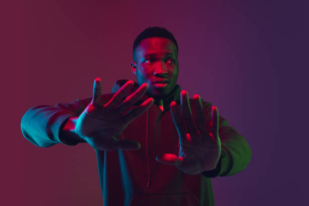 istock African-american man's portrait isolated on gradient studio background in neon light 1227383222