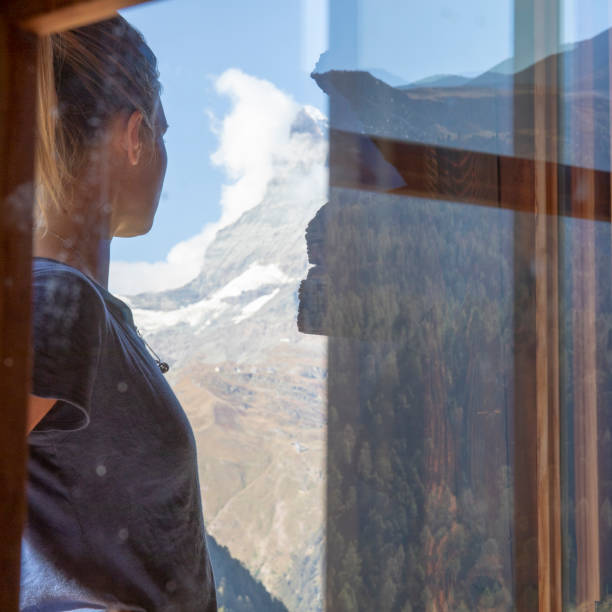 istock View past window reflection to woman at sunrise 1227384630