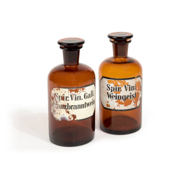 istock Two old brown apothecary glass bottles isolated on white 1227386143