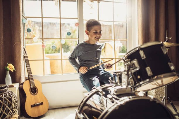 istock Father and son playing musical instruments at home 1227386170