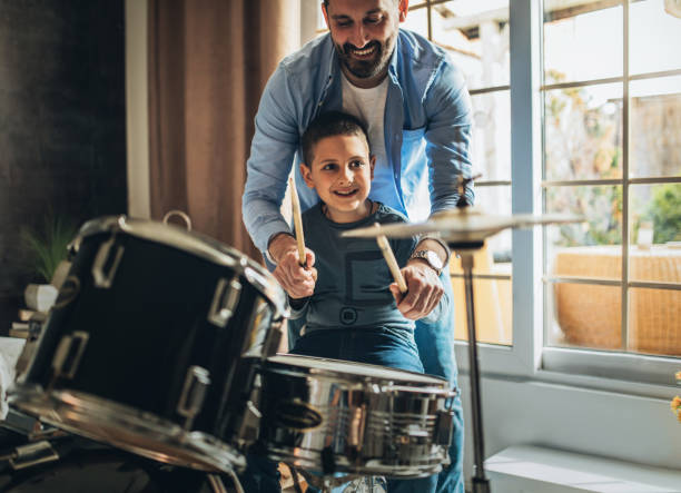 istock Father and son playing musical instruments at home 1227386315