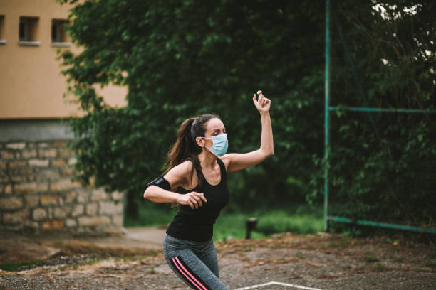 istock Woman jogging down a path boosting her immune system for covid-19 1227386457