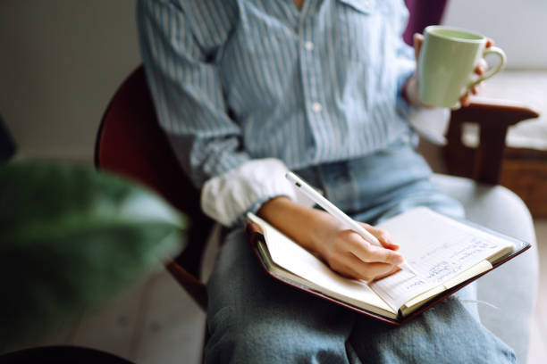 istock Beautiful woman at home writing and working with diary. 1227386744
