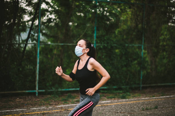 istock Woman jogging down a path boosting her immune system for covid-19 1227387367