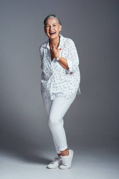 Being happy is what keeps us going Studio shot of a senior woman posing against a grey background middle aged woman fashion stock pictures, royalty-free photos & images