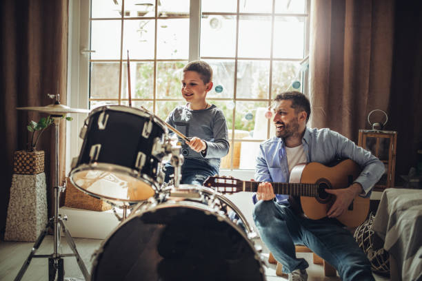 istock Father and son playing musical instruments at home 1227387430