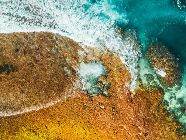 istock Drone Quadcopter with Digital Camera. Blue Ocean Water and Incredible Foamy Waves. Top Ocean Volcanic Hills in the Background. Isolated Water Splash on White Background, Bali Blue Water, 2020 1227387688