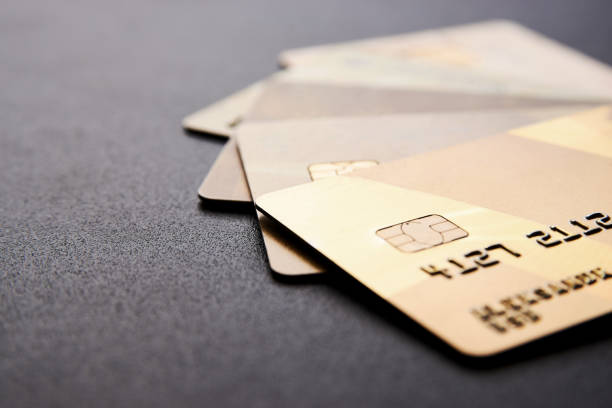 istock Gold credit cards on black background with copy space 1227388125
