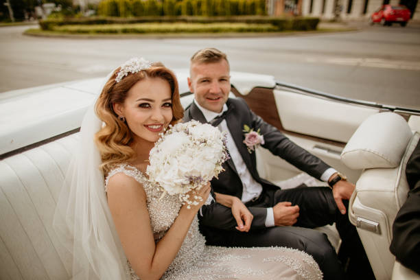 istock beautiful wedding couple posing in old retro car 1227388280