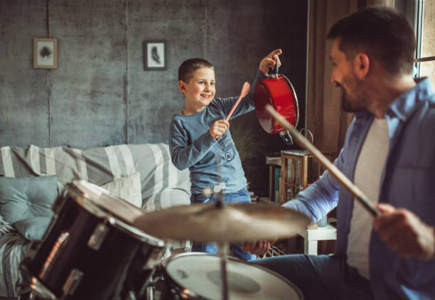 istock Father and son playing musical instruments at home 1227389398