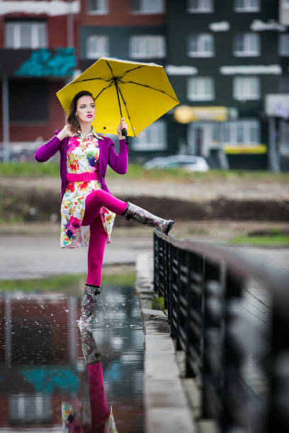 istock Woman with an umbrella 1227389825