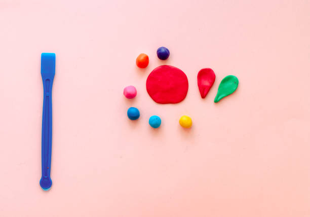 istock cute flower made of multi-colored plasticine clay on a pink background, multi-colored dough, minimal, children's crafts 1227389904