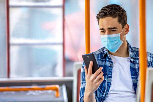 istock Men  in bus wearing face mask 1227389969