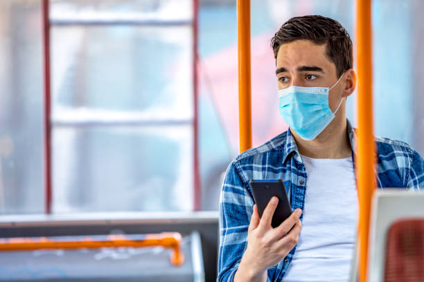 istock Men  in bus wearing face mask 1227389983