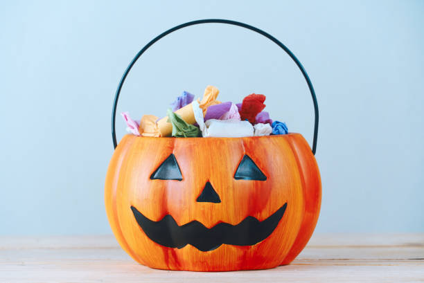 istock The candy that the children received as a gift put in a pumpkin-shaped basket which had a cool face, halloween party concept 1227391945