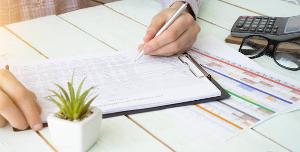 istock Businessman with calculator counting making notes at office hand is writes in a notebook 1227391947