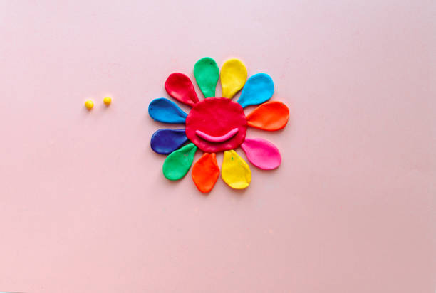 istock cute flower made of multi-colored plasticine clay on a pink background, multi-colored dough, minimal, children's crafts 1227392616