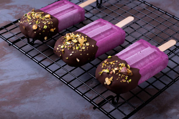 istock Bilberry ice-cream decorated with chocolate and pistachio nuts 1227392780
