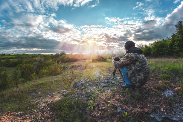 istock a man photographs a cloudy sky 1227393496