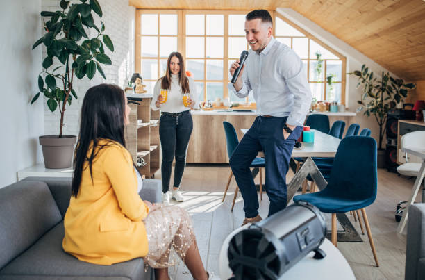 istock Friends singing and dancing at home, having a karaoke party. 1227396049