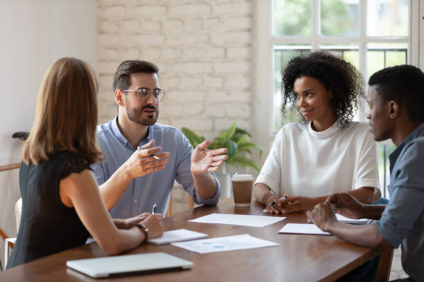 istock Diverse colleagues brainstorming, discussing project at meeting in boardroom 1227397611