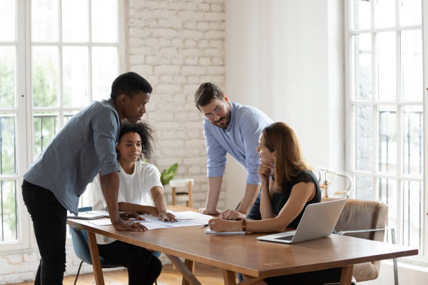 istock Serious diverse business people working on project documents at meeting 1227397612