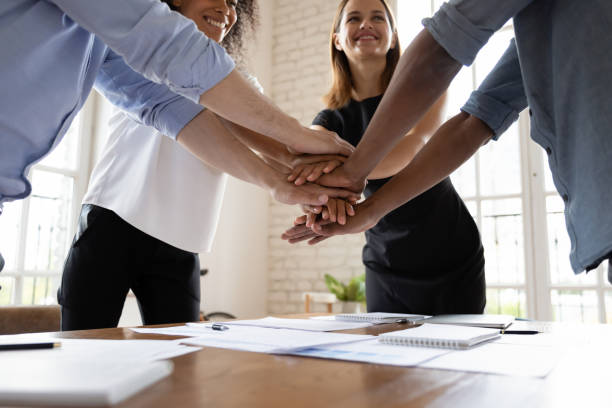 istock Happy diverse business people stacking hands, celebrating success 1227397617