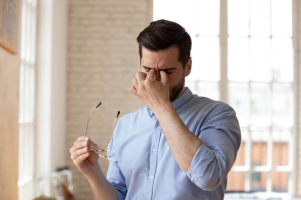 istock Tired businessman taking off glasses, suffering from eyestrain 1227397631