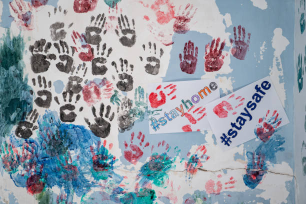 istock Multi Colored Finger Paintings On Wall With text Stay Home And Stay Safe 1227400240