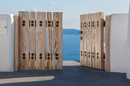 Wooden gates close access to the sea. Greece, Santorini island