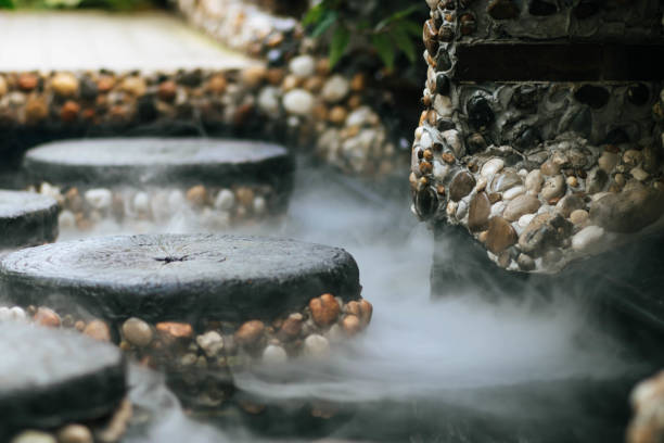 istock Defocused and blurred image for background. Hot Springs, Boiling and steaming water in geyser vent. Steaming geothermal hot water, Large stones arranged, Boiling water splash. closeup, vintage style. copy space. 1227400830