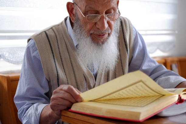 istock Elderly Muslim Turkish Man reading Holy Quran during Ramadan 1227403454