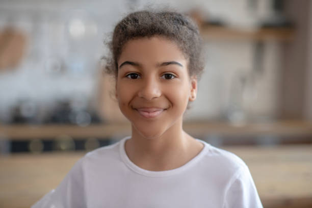 istock Cute curly-haired girl smiling and feeling happy 1227404427