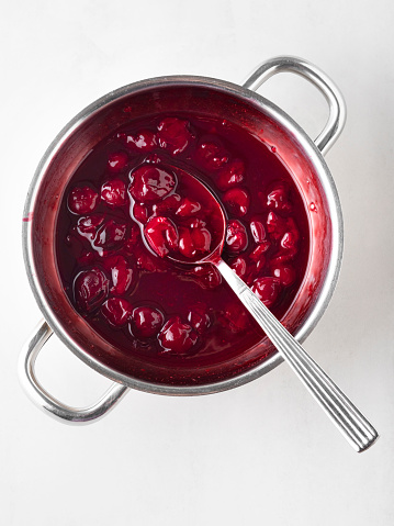 Portion of homemade cranberry sauce. Cranberry jam in white ceramic bowl. Copy space