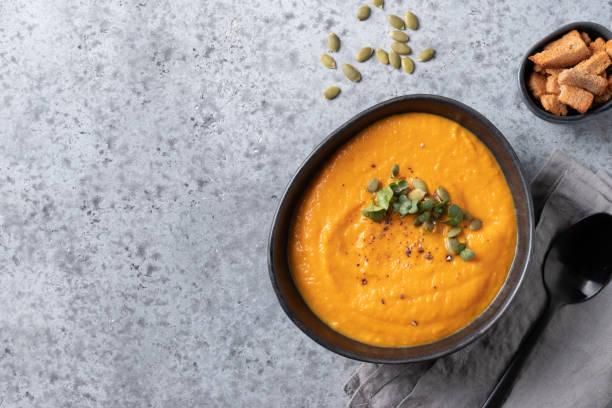 istock Fall pumpkin soup with crackers on grey background. Top view. Space for text. 1227410008