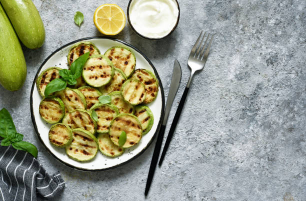 istock Grilled zucchini with sauce on concrete background. View from above. 1227411542