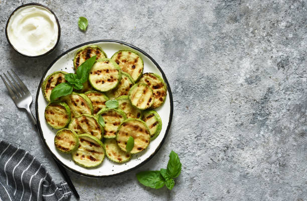 istock Grilled zucchini with sauce on concrete background. View from above. 1227411678