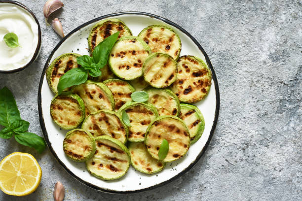 istock Grilled zucchini with sauce on concrete background. View from above. 1227411689