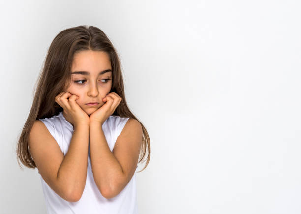 istock Bored, thoughtful little girl with both hands on her chin 1227411864