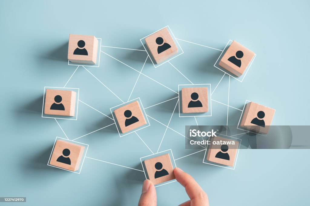 Building a strong team, Wooden blocks with people icon on pink background, Human resources and management concept. Connection Stock Photo