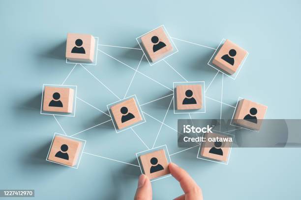 Building A Strong Team Wooden Blocks With People Icon On Pink Background Human Resources And Management Concept Stock Photo - Download Image Now