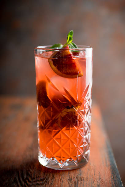 istock Red cocktail with blood oranges and mint on the rustic background 1227413027