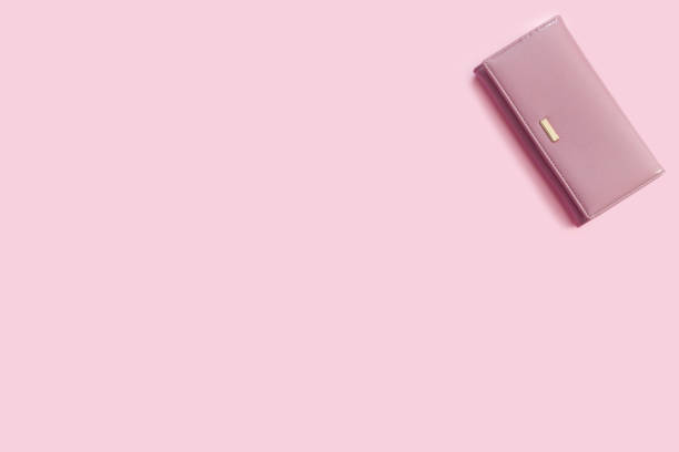 istock Beautiful delicate pink background with a leather wallet. 1227413496